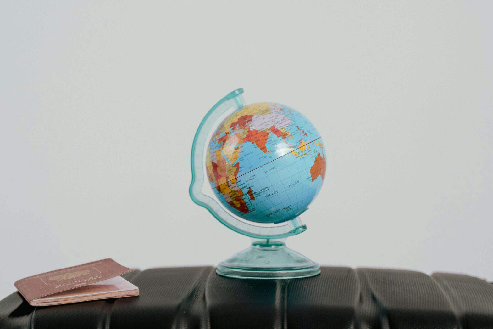 Globe and passport on a suitcase