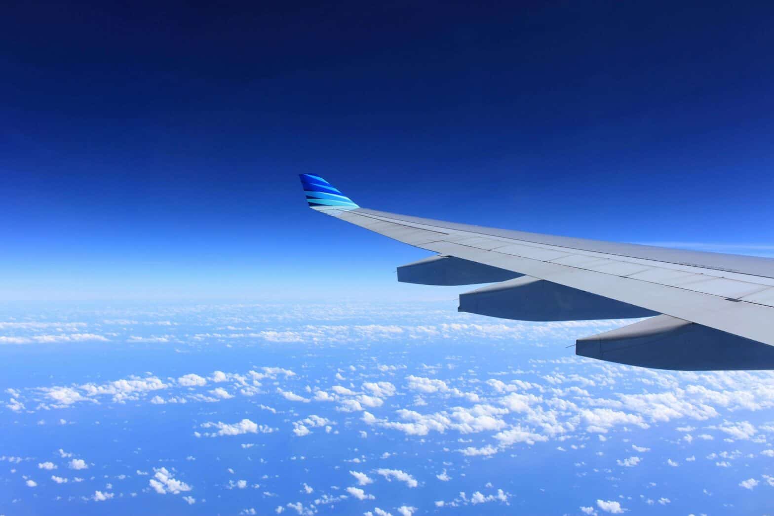 airplane wing over blue sky